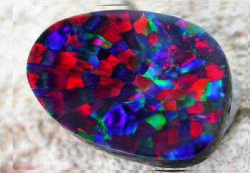 Harlequin OpalIn a recent post I was discussing the poetic traditional nomenclature in the gem world