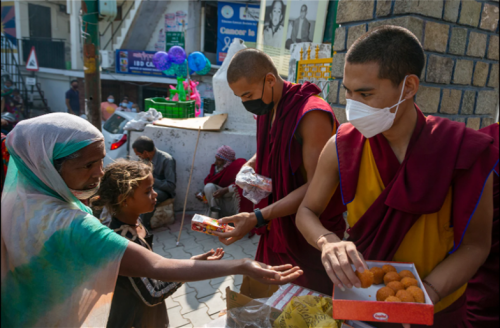 divinum-pacis:Exile Tibetan Buddhist monks distribute sweets and packets of juice to the public to c