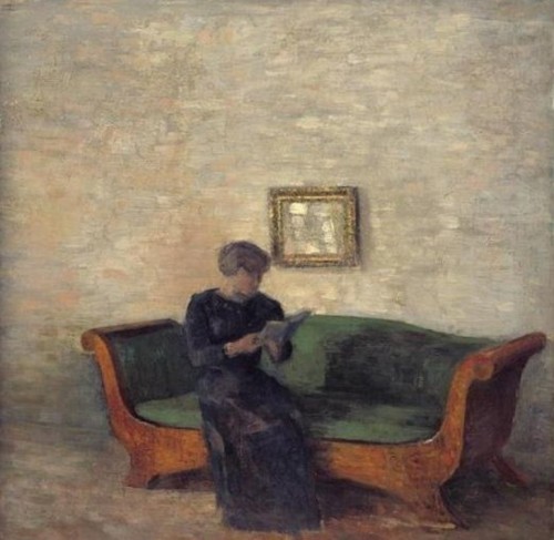 Interior with a Lady seated on a Birchtree sofa reading a book (1903). Vilhelm Hammershøi (Danish, 1