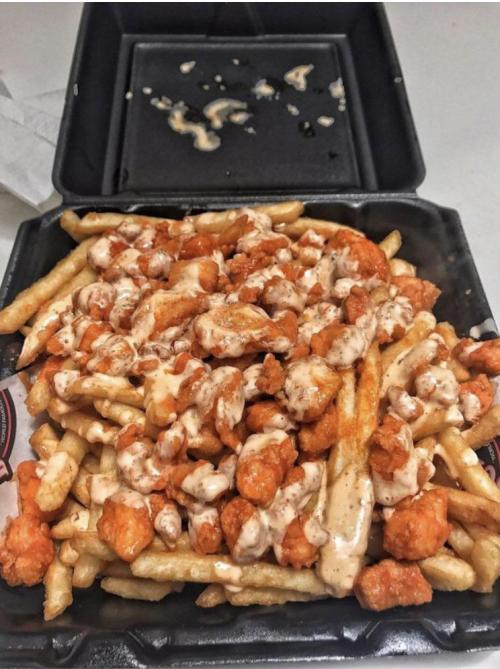 lifejoyaddict:  Cheese fries topped with boneless buffalo wings 🤤