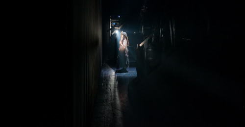 Mckayla Twiggs is revealed as Young Cosette, with broom in hand, and waits for the scrim to rise. Ph