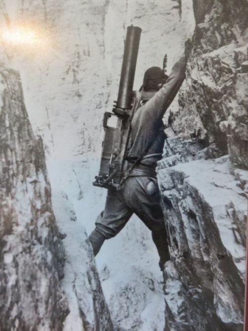 Italian alpini climbing with machine gun, World War I.