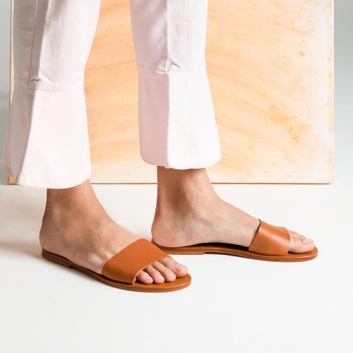 Beautiful tan banded sandals on pretty feet.