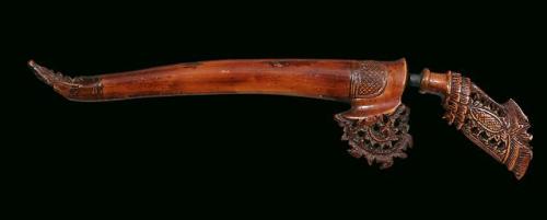 Kris with carved scabbard and hilt, Indonesian, 19th century.from Karabella Auctions
