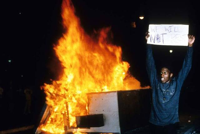 CultureHISTORY: The Los Angeles Uprising - 25th Anniversary (Pt. 1) - April 29, 2017 Photos and captions via the Los Angeles Times, LA Daily News, AP and CBS News. (Pt. 2)We will not rest A protestor at Parker Center. April 29, 1992Look what you created - Shopping mall goes up in flames at the intersection of La Brea and Pico where someone with a spray can left a statement about violence. LA Times Photo Kirk McKoySandra Evers-Manley, president of Beverly Hills-Hollywood chapter of NAACP, appears to be praying as building burns the first night of the riots. Gary Friedman / Los Angeles TimesFires rage on both sides of Western Avenue along Santa Monica Blvd. in Hollywood at about 6pm 4/30/1992. Ken Lubas / Los Angeles TimesA man flees from a looted sporting goods store at Vermont and 1st Street as LAPD officers arrive on April 30, 1992.A National Guardsman stands guard in a burned out business area at Vermont Avenue and Wilshire Boulevard in Los Angeles, April 30, 1992 during the second day of rioting in the city. (AP Photo/David Longstreath)LA County Sheriffs surround alleged looters on Vermont at ML King Blvd. Taken 4/30/92 Photo/Art by Steve Dykes Los Angeles TimesAn LAPD officer falls while chasing a suspected looter on Vermont near MLK Boulevard on April 30, 1992. The man was caught and subdued soon after. Steve Dykes / Los Angeles TimesLAPD officers stand guard as fire units battle a blaze near 19th Street and Adams Boulevard on April 30, 1992. #culturehistory#culturela #los angeles uprising #culturesoul#black tumblr#black history#racism#resistance