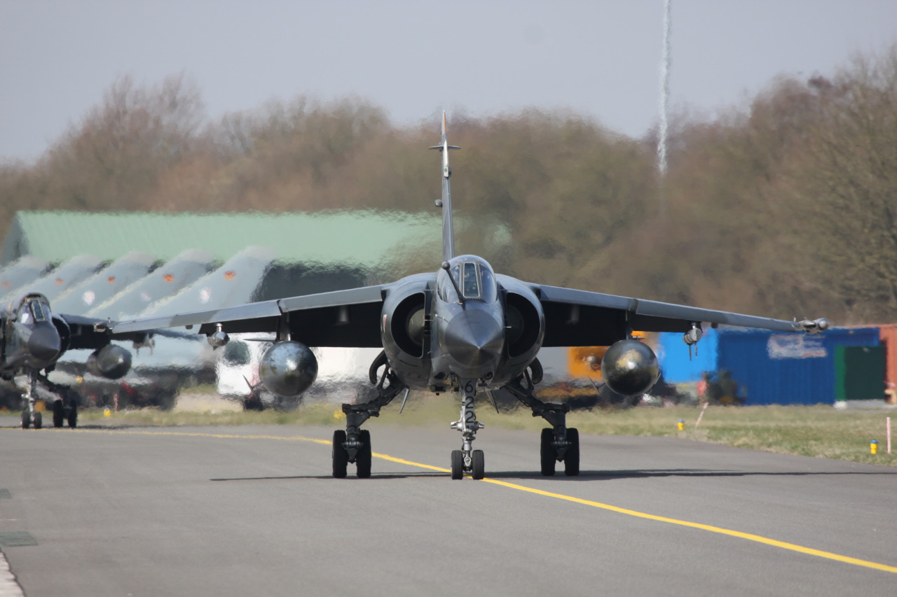 nemoi:  Mirage F1CRs taxi in past a line up of seven Luftwaffe Eurofighters (via