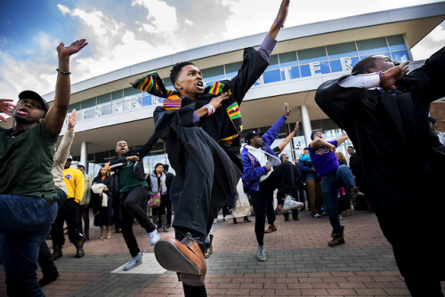 A graduating student and fellow members of the Omega Psi Phi Fraternity perform a step routine after