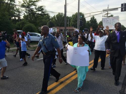 blacknoonajade:  Captain Ron Johnson of the Missouri Highway Patrol walks WITH and LEADS Ferguson Protesters, letting them know,  “I grew up here."  Thank you, brother. Thank you.  