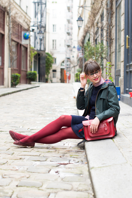 Daphné in red opaque tights, flat shoes, blue wool dress and green jacket