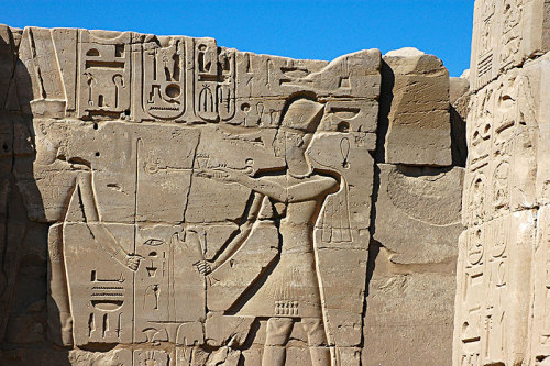 King Ramesses II before Amun-ReDetail of a sunken relief depicts king Ramesses II censing and pourin