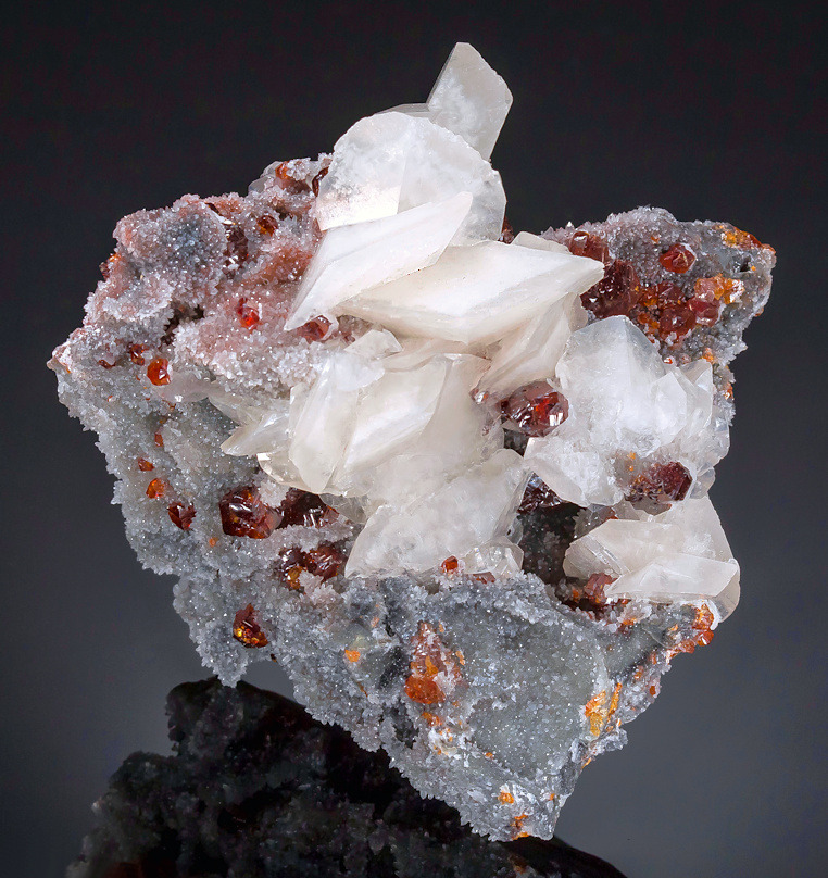 vugnasmineralblog:   Calcite and  Sphalerite on Quartz Shuikoushan Mine, Shuikoushan