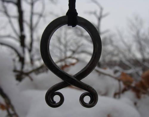 thebubblingcauldron:     The troll cross is an amulet made of a circle of iron crossed at the bottom, a charm worn by early Scandinavian peoples as a protection against trolls and elves. Iron and crosses were both believed to ward off evil creatures 