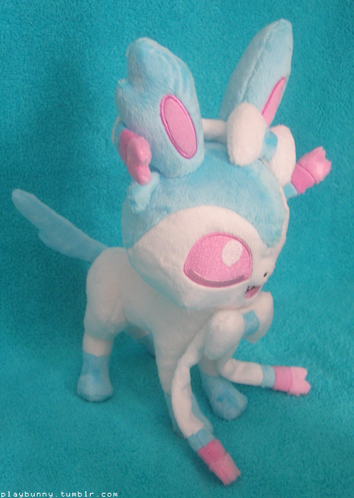 I am legit screaming everywhere right now !! Look at what I got today !! This is a shiny Sylveon plush I commissioned the lovely spacevoyager for of my in game, shiny female Sylveon, Charlie.  She’s absolutely perfect and stands up well on her