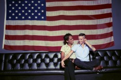 lgbtgivesmehope:  [Two women kiss in front of the American flag]