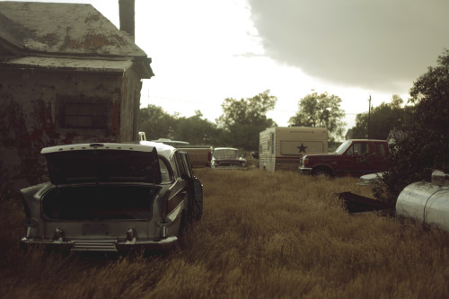 kylejthompson:  I found a ghost town while driving though the midwest. I spent the day wading through dead grass and exploring the vacant homes.  A rusty water tower lay on the outskirts of the town and the yards were littered with old cars.  New life