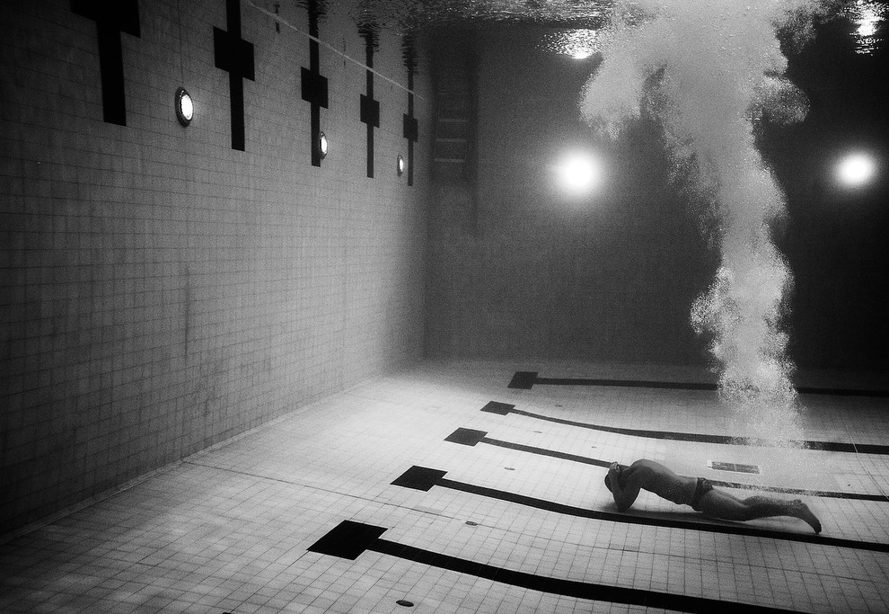  A diver has a very personal moment of dejection at the bottom of the pool during
