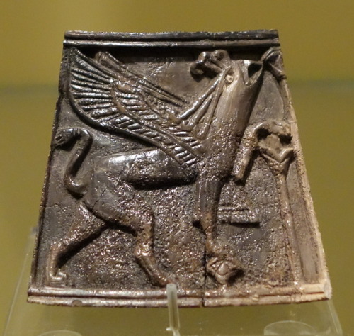 Ancient Assyrian ivory box panel depicting a griffin and sacred tree.  Artist unknown; ca. 800 BCE. 