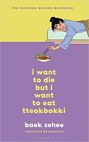 The cover of I Want To Die, But I Also Want To Eat Tteokkbokki, which is split in two different colours, yellow top, purple bottom, with a bed and a girl laying on her front on it with a bowl of tteokkbokki laying on the floor as the girl picks from it with a pair of chopsticks. The title is written in bold yellow font at the bottom and the author's name is in white below it. 