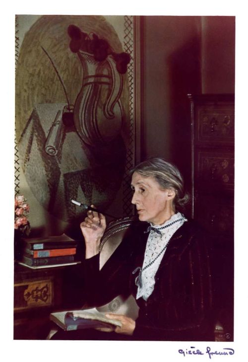 books0977:Virginia Wolff smoking while reading. Photograph by Gisèle Freund (German, 1908-2000)In Lo