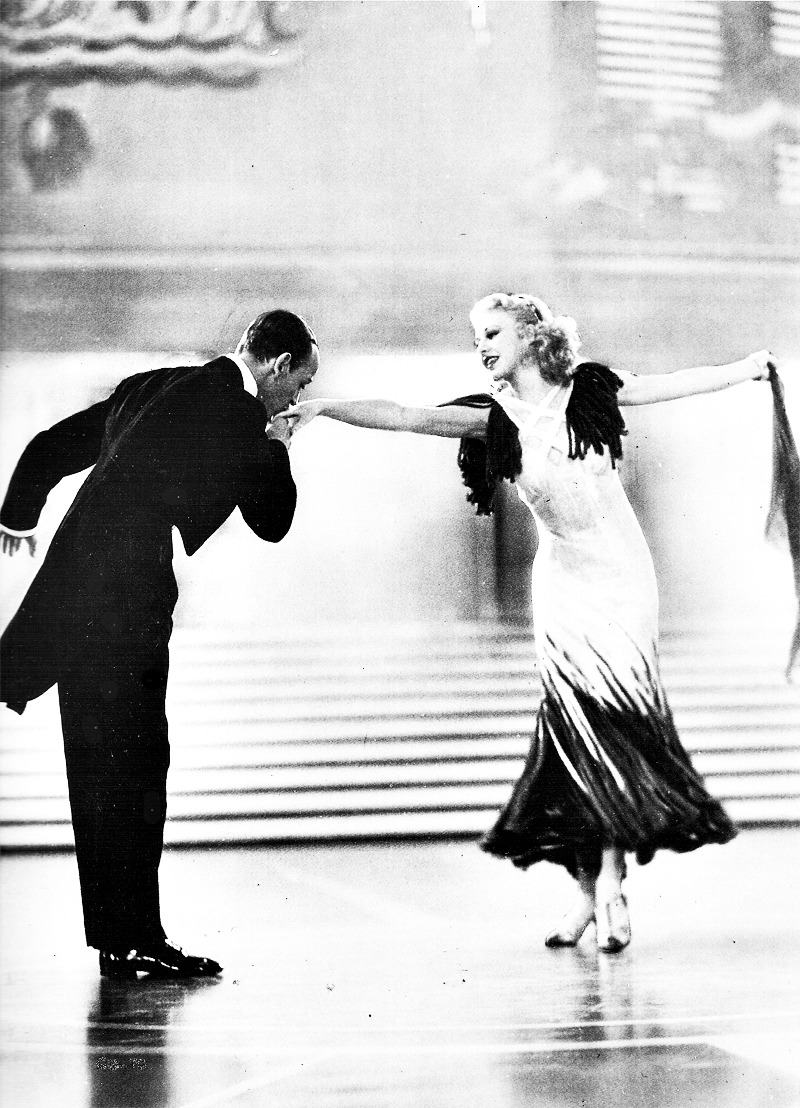 astairical:  Fred Astaire gives Ginger Rogers a kiss on the hand in The Gay Divorcee