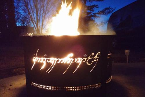 This Lord Of The Rings fire pit has text inscribed on the side of the panel that is only readable wh