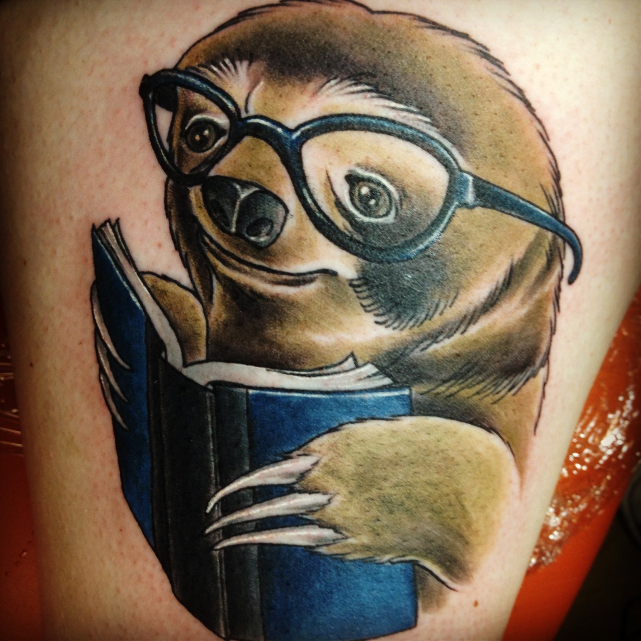 fuckyeahtattoos:  sloth reading a book  Done by Katie at Blue Byrd in Middletown,