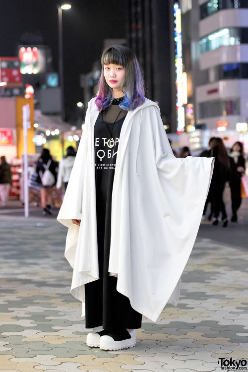 Elleanor on the street in Harajuku wearing a hooded &ldquo;RIOT&rdquo; cape from the Finland