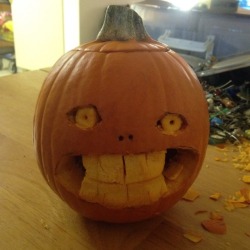 kramergate:my mom wanted a pumpkin from me very badly even though im not good at carving them at all so this is what she got. his name is Horrible Gourd