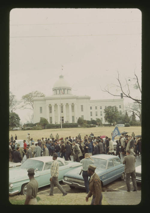 Martin Luther King Jr. leading a procession of people to demonstrate against police treatment of vot