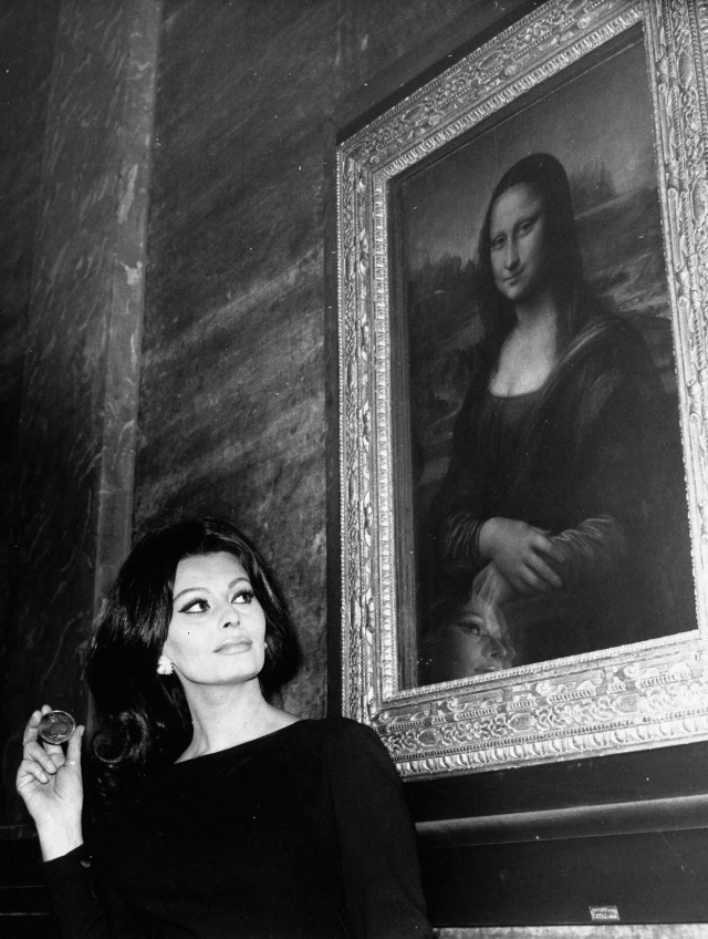 Sophia Loren admiring the Mona Lisa at the Louvre Museum in Paris. 1964