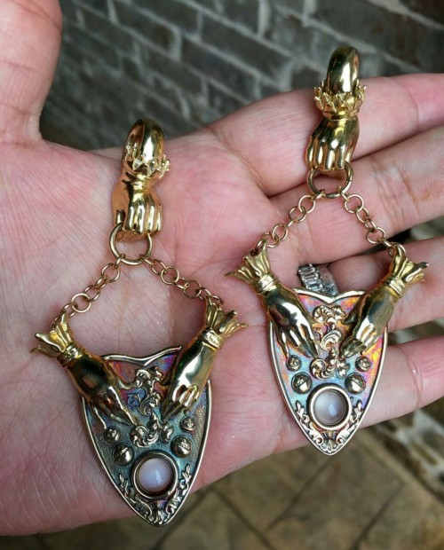 Lovely customer shot of our Séance planchette ear weights in oxidized brass with 14k gold-filled han