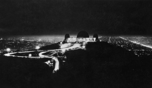 The Griffith Observatory at night, with the street lights of the Los Angeles basin burning bright in the background, 1940.