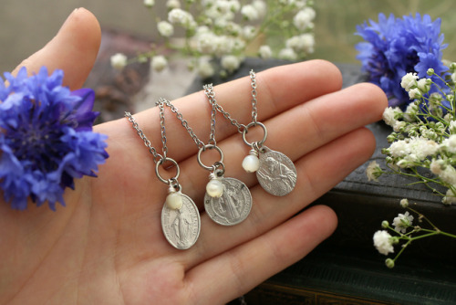 Antique white rosary mother of pearl beads and vintage pilgrim medals made into elegant necklaces.Av