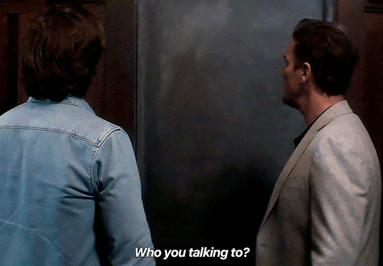 GIF FROM EPISODE 3X08 OF NANCY DREW. ACE AND RYAN ARE STANDING IN THE ARCHIVE ROOM OF THE HISTORICAL SOCIETY, IN FRONT OF THE CLOSED DOOR. RYAN SAYS "WHO YOU TALKING TO?"