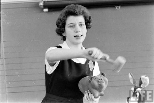 Young auctioneer demonstrating her job to classmates(Robert W. Kelley. 1961)