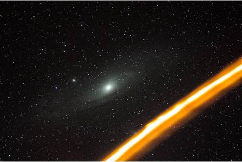 Meteor trail on the background of the Andromeda GalaxyPhoto by astrophotographer: Charles Chiofar