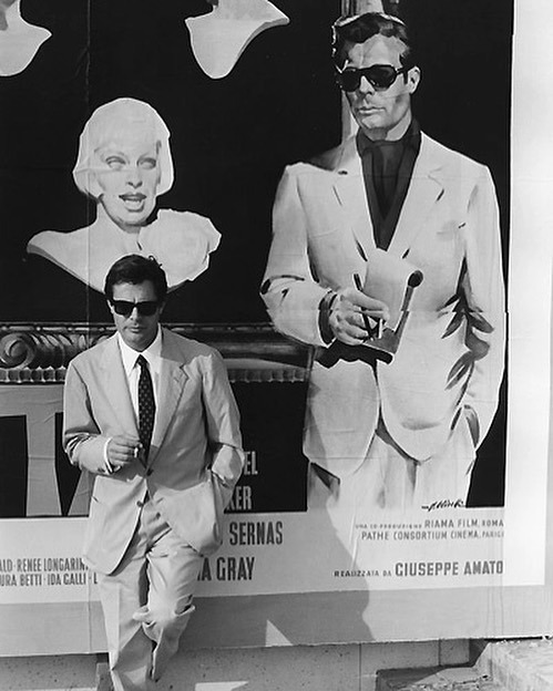 lucienballard:  Marcello Mastroianni in front of a poster for La Dolce VitaMay1960