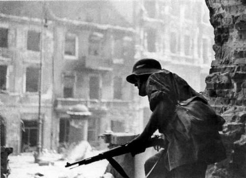 warhistoryonline:Warsaw Uprising - Polish resistance fighter with a German helmet and K98 rifle, War