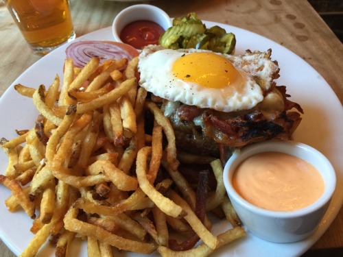 Mayfield&rsquo;s dry aged burger with blue cheese, bacon, smothered onions and sunny side up egg cov