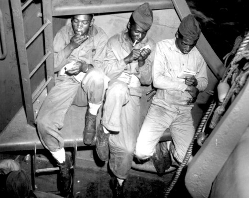  “Relaxing aboard a U.S. Coast Guard-manned transport headed for Pacific invasion areas, three Negro