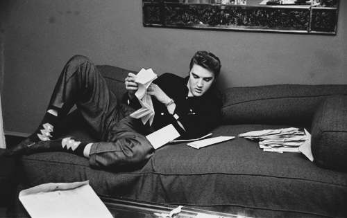 presley-elvis:  Elvis Presley reads fan mail at The Warwick Hotel, New York on March 4, 1956. Photographs taken by Alfred Wertheimer. 