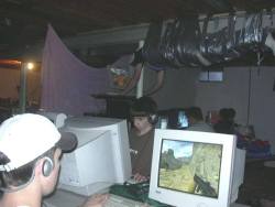 puckish-thoughts: THERE IT IS AGAIN!  THERE IT FUCKING IS!  i’VE BEEN TALKING ABOUT THIS PHOTO FOR YEARS AND NEVER COULD FIND IT!!  THE LAN PARTY WITH THE GUY DUCT-TAPED TO THE CEILING!!  BACK IN ANCIENT TIMES WHEN PEOPLE STILL USED CATHODE MONITORS