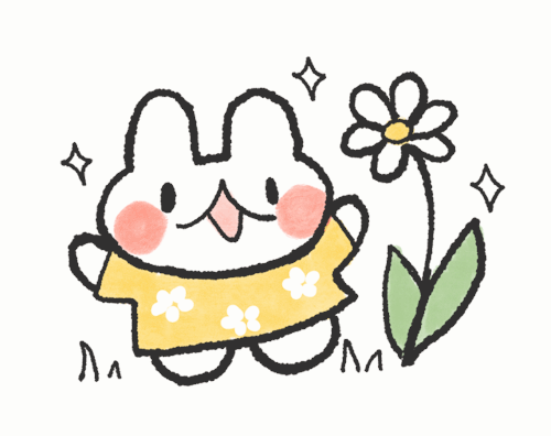a bunny wearing a yellow shirt smiling at a big white flower.