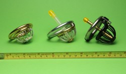youralphagirl:  Here are the latest three chastity devices my bf trox has built on my request. The oldest is the black one on the right side with a length of 50 mm and a solid brass plug protruding 28 mm. The one in the middle is 37 mm in total length
