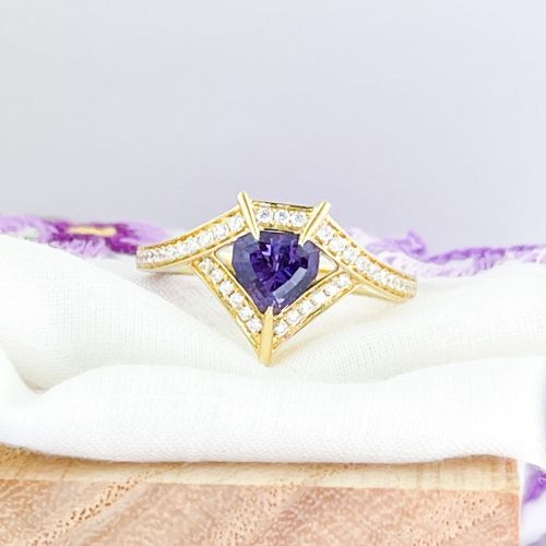 No heat purple sapphire shield cut in 18K yellow gold. We are really digging the shields. We&rsquo;v