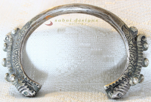 Antique Hmong silver bracelet with dragon-head design at sabai designs gallery.