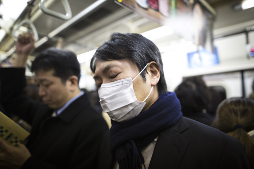 TOKYO, JAPAN - DECEMBER 12 : A salaryman rest for a while as he commute home in Marounouchi subway o