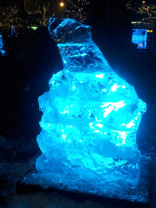 Ice carving in Piccadilly Gardens, Manchester. The LED backlighting helps and helps to show off some