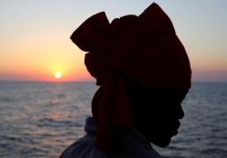 troposphera:  A migrant looks on from Vos Hestia ship after being rescued by “Save the  Children” NGO crew in the Mediterranean sea off Libya coast.  REUTERS/Stefano Rellandini