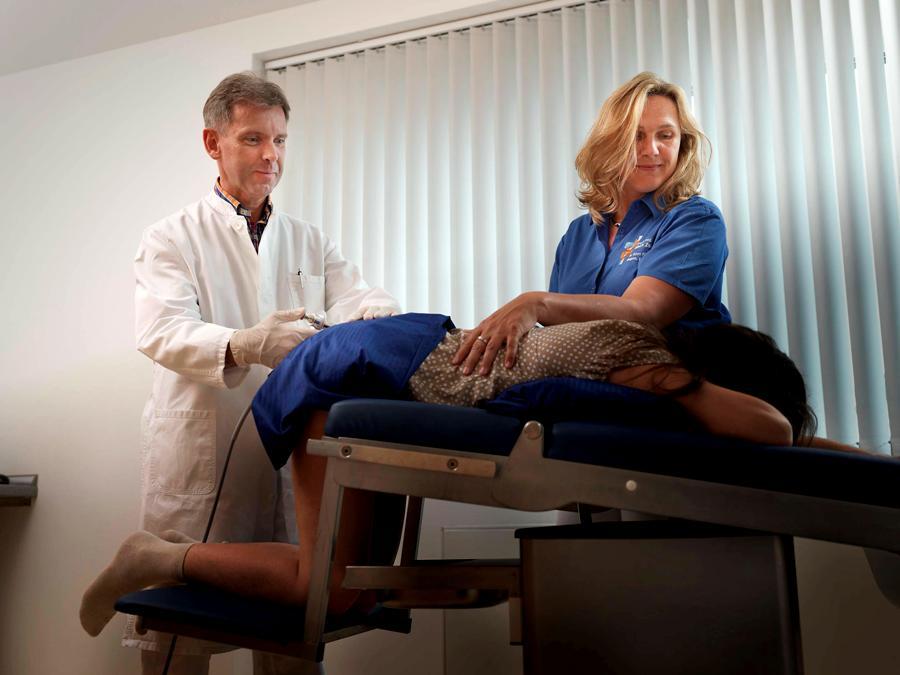 gynie-ville:  At the proctologist, she leans over the tilt-table for a thorough rectal